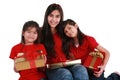 Three sisters holding presents