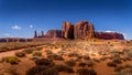 The Three Sisters and Mitchell Mesa, a few of the many massive Red Sandstone Buttes and Mesas in Monument Valley Royalty Free Stock Photo