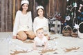 Three sisters posing in front of Christmas tree Royalty Free Stock Photo