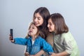 Three sisters posing and taking selfies in the studio Royalty Free Stock Photo