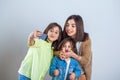 Three sisters posing and taking selfies in the studio Royalty Free Stock Photo