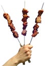 Three skewers of shish kebabs in a hand of the man Royalty Free Stock Photo