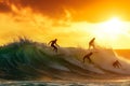 Three skilled surfers riding a wave as the sun sets in a thrilling display of athleticism and ocean expertise, A group of surfers Royalty Free Stock Photo