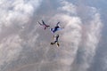 Formation skydiving. Three skydivers are in the sky. Royalty Free Stock Photo