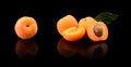 Three sliced apricots isolated on black