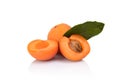 Three sliced apricots with leaf on white Royalty Free Stock Photo