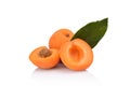 Three sliced apricots with leaf on white Royalty Free Stock Photo