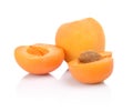 Three sliced apricots on white