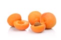 Three sliced apricots on white