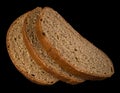 Three slices of dark bread on a black background isolated Royalty Free Stock Photo