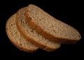 Three slices of dark bread on a black background isolated Royalty Free Stock Photo