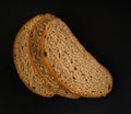 three slices of dark bread, on a black background in isolation Royalty Free Stock Photo