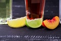 Three slices of different fruit and glasess with coctails on a b Royalty Free Stock Photo