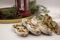 The three slices and the main part of Stollen with Christmas ornaments on a white background. Traditional German Christmas cake Royalty Free Stock Photo