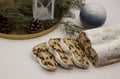 The three slices and the main part of Stollen with Christmas ornaments on a white background. Traditional German Christmas cake Royalty Free Stock Photo