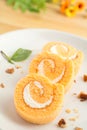 Three slices of orange roll cake