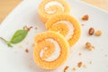 Three slices of orange roll cake