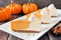 Three slices of pumpkin cheesecake on white serving plate