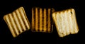 Three slices of toasted bread on the grill on a black background. Toast bread. Royalty Free Stock Photo