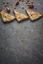 Three slices of whole wheat bread with hummus, chickpea and garlic on the grey concrete backdrop Royalty Free Stock Photo