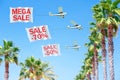 Three small aircraft towing banners with SALE