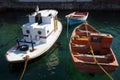 Three small boats tied up in jetty in small fishing village Royalty Free Stock Photo