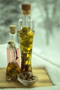 Three small bottles of olive oil on the balcony in the winter. Royalty Free Stock Photo