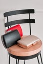Three small clutch of red, black and beige on a chair. The white background Royalty Free Stock Photo