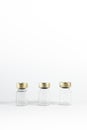 Three small empty glass vials on a white background. Medicine bottles. Copy space. vertical Royalty Free Stock Photo