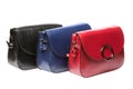 Three small female clutch bags, black, blue and red bags on a white background isolate Royalty Free Stock Photo