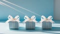 Three small gift boxes tied with ribbons on a blue surface. Royalty Free Stock Photo