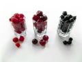 Three small glasses of cherry, raspberry and blackcurrant fruit