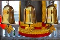 The three small gold bells hung in front of The big black bell in thai temple
