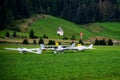 Three small planes parked on a field with a barn in the background. Royalty Free Stock Photo