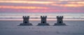 Three Small Sandcastles on a Beach at Sunset. Royalty Free Stock Photo