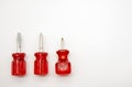 Three small screwdrivers with red handles on a white background Royalty Free Stock Photo