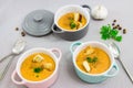 Three small serving pots or bowls with cream soup made of red lentils with rusks, spices and herbs parsley, coriander Royalty Free Stock Photo