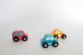 Three small toy cars pink, yellow and blue wirth white background Royalty Free Stock Photo