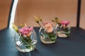 Three small vases with roses and lisianthus Royalty Free Stock Photo