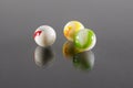 Three Small White Ceramic Balls with Veins and Black Background