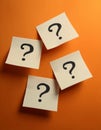Paper notes with question marks on orange background, flat lay. Space for text Royalty Free Stock Photo