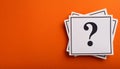 Paper notes with question marks on orange background, flat lay. Space for text Royalty Free Stock Photo