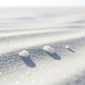 Three small white stones rest on a bed of fine, white sand. The sand glimmers under the light, Royalty Free Stock Photo