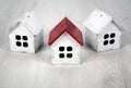 Three small wooden houses on a wooden background Royalty Free Stock Photo