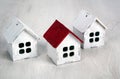 Three small wooden houses on a wooden background Royalty Free Stock Photo