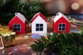 Three small wooden houses on a New Year\'s background. Christmas tree pendants made of wood Royalty Free Stock Photo