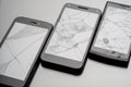 Three smartphones whose screens are broken and cracked Royalty Free Stock Photo