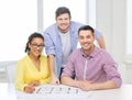 Three smiling architects working in office