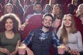 Three smiling best friends spending free time at cinema. Royalty Free Stock Photo