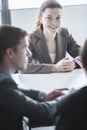 Three smiling business people sitting at a table and having a business meeting in the office Royalty Free Stock Photo